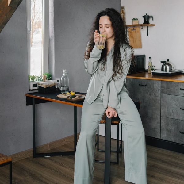 Person meditating calmly in a serene environment, radiating peace.